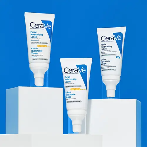 Woman with a radiant glow on her face, holding CeraVe Advanced Repair Ointment
